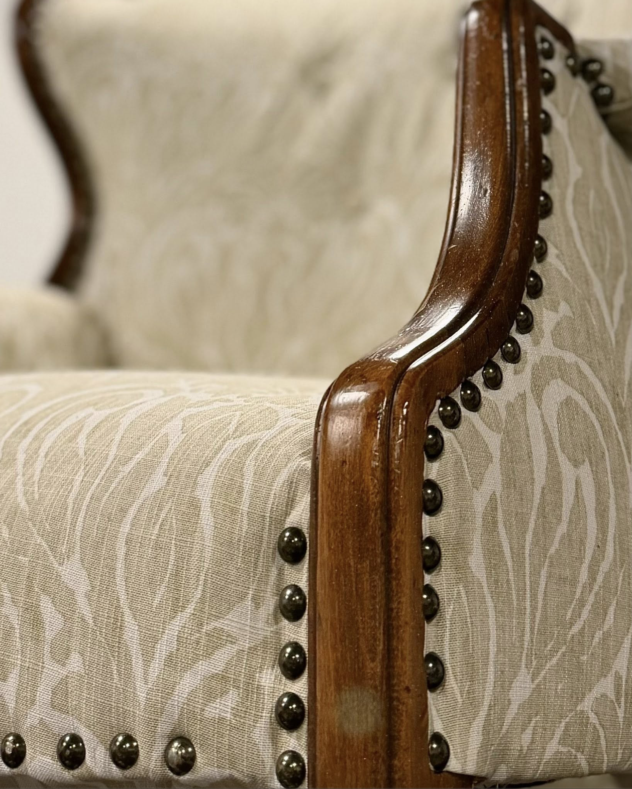 Hand-upholstered chair detail with nailhead trim